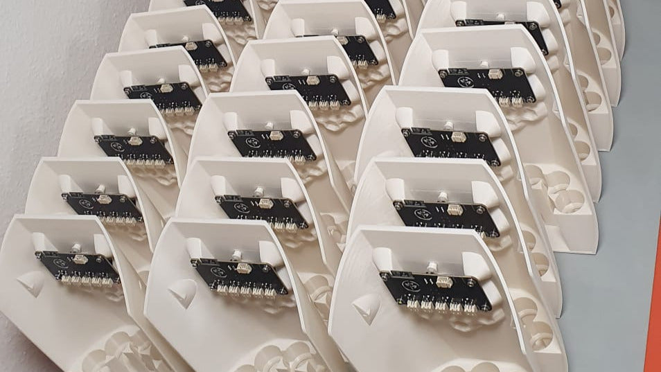 PlantMate smart planter base units with integrated circuit boards in production batch at Plantup manufacturing facility