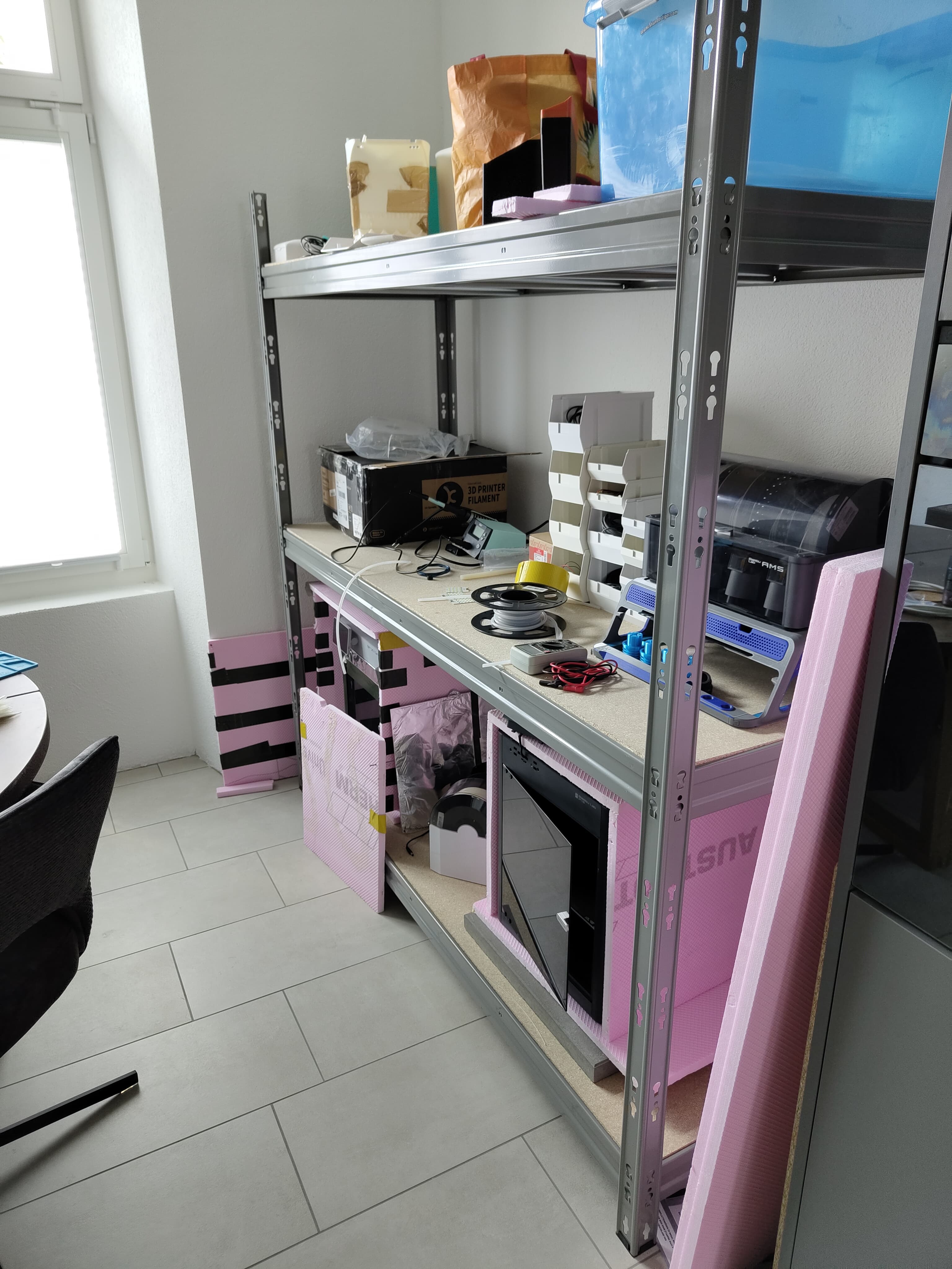 PlantMate manufacturing workspace with 3D printing equipment for automatic plant watering system production in Switzerland