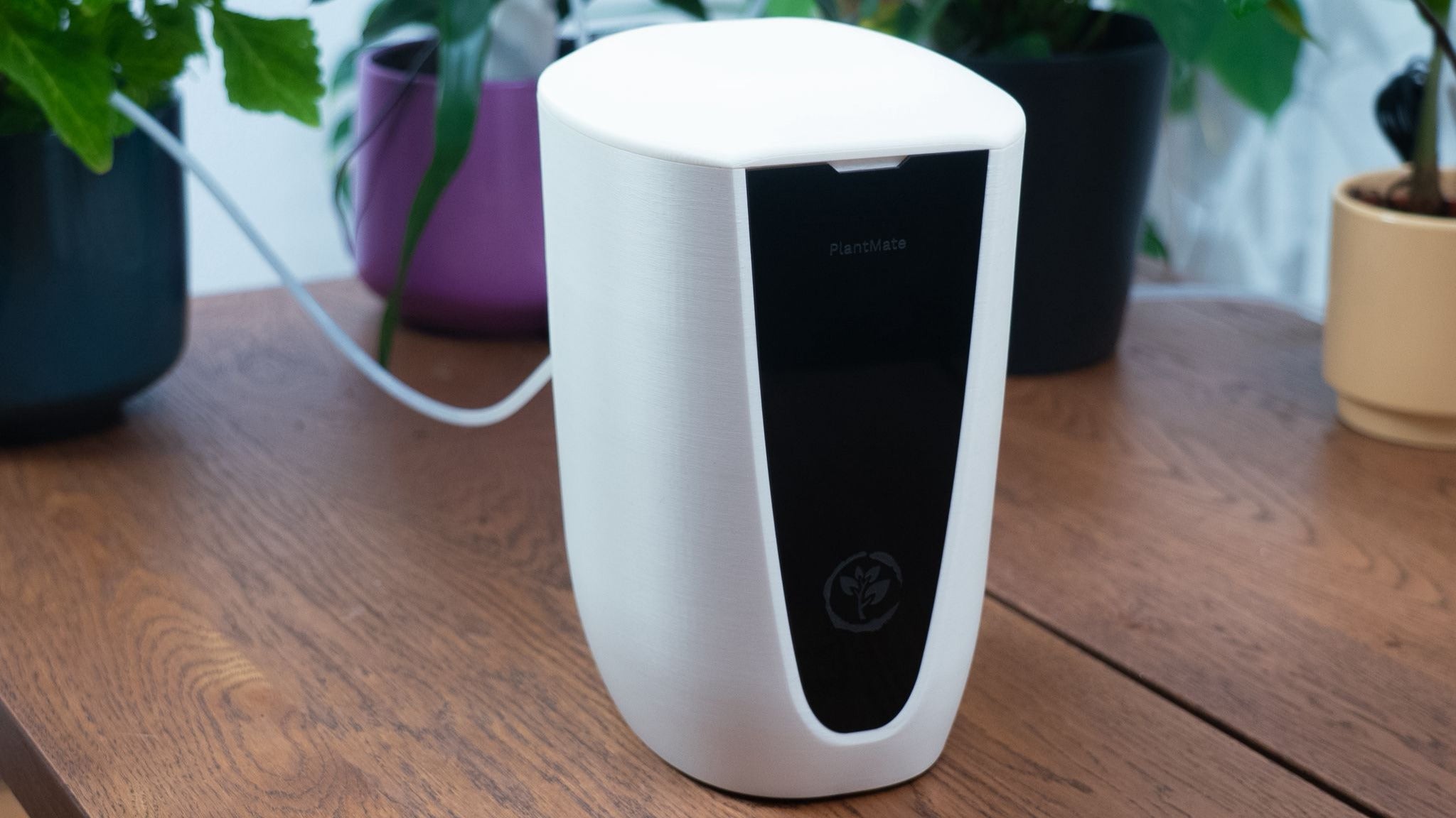 PlantMate smart planter finished product with sleek white design and black display panel by Plantup