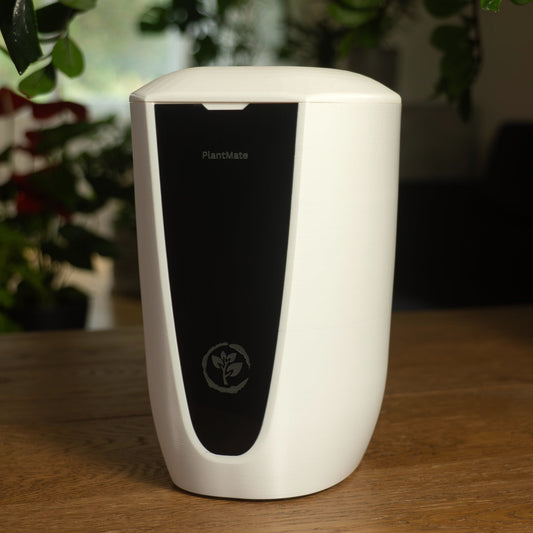 PlantMate Swiss automatic plant watering system front view with black display panel and plant care logo