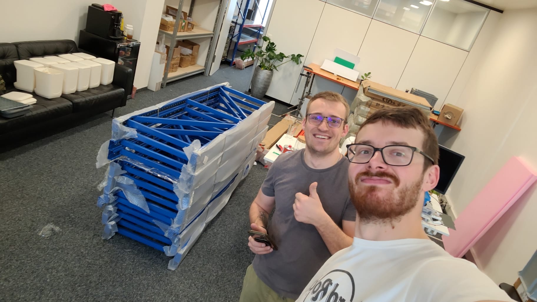 PlantMate team assembling automatic plant watering systems in Swiss manufacturing facility with product inventory